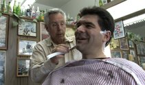 John Katsilometes chats with Mayor Pro Tem Gary Reese at his place of employment: the barber shop.