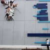 A worker adds the finishing touches to a building at the Olympic Green on Monday in Beijing, where U.S. basketball players will bid for redemption on the world stage.