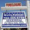 An auction sign for a foreclosed home in Las Vegas bends in the wind, Nov. 17, 2010.