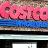 In this Dec. 7, 2011, file photo, a shopper leaves Costco in Portland, Ore.