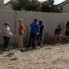 Ashlee Coate, right, and Chloe Jones, both 15, clean up graffiti Saturday morning near U.S. 95 and Charleston Boulevard along with other participants of a student ministry at the Crossings Christian Church.
