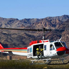 In this photo provided by the National Transportation Safety Board on Saturday, Dec. 10, 2011, investigators examine the wreckage of a sightseeing tour helicopter from Las Vegas that crashed in the Lake Mead National Recreation Area in Nevada near the Hoover Dam. The Wednesday, Dec. 7, 2011, crash killed the pilot and four tourists, including a couple from Kansas and a couple from New Delhi, India. 