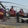 Mechanics work on a grounded Sundance tour helicopter on the tarmac at McCarran International Airport Thursday, Dec. 8, 2011, in Las Vegas. A Sundance tour helicopter crashed killing the pilot and four passengers on Dec. 7. 