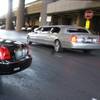 A Bell Transportation limousine driver talks to passengers after picking them up at McCarran International Airport on Thursday, Dec. 3, 2009. 
