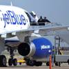 Emergency workers tend to a JetBlue captain that had a "medical situation" during a Las Vegas-bound flight from JFK International airport, Tuesday, March 27, 2012, in Amarillo, Texas. Passengers said the pilot screamed that Iraq or Afghanistan had planted a bomb on the flight, was locked out of the cockpit, and then tackled and restrained by passengers. The pilot who subsequently took command of the aircraft elected to land in Amarillo at about 10 a.m., JetBlue Airways said in a statement.