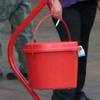 In this Nov. 22, 2017, file photo, a patron donates money in a Salvation Army red kettle in Wilkes-Barre, Pa.