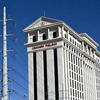 In this Monday, Jan. 12, 2015, photo, a man takes pictures of Caesars Palace in Las Vegas.