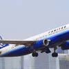 A United Airlines passenger jet is shown on the ground as a Southwest jet takes off at McCarran International Airport on Dec. 9, 2011.