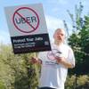 Demonstrators protest against ride-hailing company Uber in Carson City on Monday, March 30, 2015.
