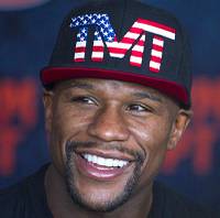 In this Sept. 12, 2014, file photo, Floyd Mayweather Jr. poses on the scale during a weigh in for a fight against Marcos Maidana in Las Vegas. In this Sept. 12, 2014, file photo, Floyd Mayweather Jr. poses on the scale during a weigh in for a fight against Marcos Maidana in Las Vegas.