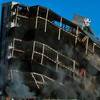 The Gramercy real estate project implodes its 9-story residential tower Sunday, Feb. 15, 2015, in Las Vegas.