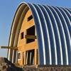 Aeron Tozier, shown Saturday, March, 28, 2015, is building a large, eco-friendly, arch-shaped home in Henderson. He will live there, but it's also a prototype, as he hopes to build a business developing such homes. 