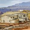 A carpenter takes a measurement at a custom home under construction in the Ridges Las Vegas, a luxury residential community in Summerlin, Thursday, June 11, 2015.