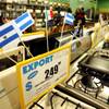 A stove is adorned by a price tag and flags of the Latin American countries that it is deliverable to at a La Curacao store, now Curacao, in Los Angeles on Tuesday, March 14, 2006.