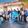 Members of the Opendoor national real estate firm pose for a photo in front of one of their properties.