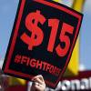 A woman holds a "Fighting for $15" minimum wage sign  during a demonstration by a McDonald's restaurant at Flamingo Road and Eastern Avenue in Las Vegas Friday, June 14, 2019. STEVE MARCUS