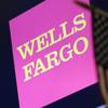 In this May 17, 2018, file photo, the logo for Wells Fargo appears above a trading post on the floor of the New York Stock Exchange.