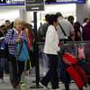 Passengers wait in line at a security checkpoint at Miami International Airport, Friday, Jan. 18, 2019, in Miami.