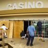 A crew boards up an entrance to the Strat Hotel and Casino due to a statewide mandated coronavirus temporary closure of nonessential businesses Wed., March 18, 2020. Nevada Gov. Steve Sisolak ordered casinos and all other nonessential businesses in Nevada to close for 30 days to help with the spread of covid-19. YASMINA CHAVEZ