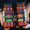 Monica Marful and her husband Alfonso Fredesvinto Perez pose with a sample of their sauces in North Las Vegas Tuesday, Sept. 7, 2021. The small business owners received an IMPACTO Hispanic Business Accelerator grant from PepsiCo.