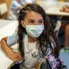 Elena Choi, 5, puts on her mask as she starts kindergarten during the first day of school Aug. 9, 2021, at Hannah Marie Brown Elementary School in Henderson. 