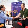 Drina Wolf shakes hands with Edward Ugarte, a Marine Corp. and Navy veteran, at the Veterans Benefit Guide booth during an EmployNV Business Hub Veterans Job and Resource Fair at the West Sahara Library Tuesday, May 2, 2023.