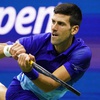 Novak Djokovic, of Serbia, returns a shot to Alexander Zverev, of Germany, during the semifinals of the U.S. Open tennis championships, Friday, Sept. 10, 2021, in New York. 