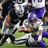 Minnesota Vikings quarterback Joshua Dobbs (15) gets tackled by Las Vegas Raiders defensive end Malcolm Koonce (51) during the second half of an NFL football game at Allegiant Stadium Sunday, Dec. 10, 2023.