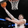 UConn center Donovan Clingan (32) goes to the basket against Northwestern forward Blake Preston during the first half of a second-round college basketball game in the NCAA Tournament, Sunday, March 24, 2024, in New York.