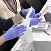 Election workers process mail-in ballots during a nearly all-mail primary election in Las Vegas, June 9, 2022.