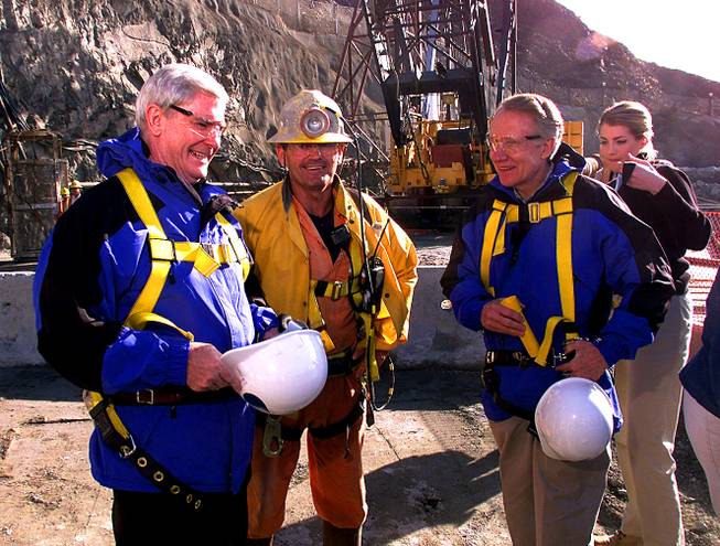 From left, Governor Kenny Guinn, miner Jay Stone and Senator Harry Reid get ready to descend into the new water intake tunnel at Lake Mead with the help of Southern Nevada Water Authority public information officer Kristen Howey during the "Last Man Out" event Saturday, January 22, 2000.