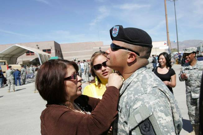Spc. Daniel Ulino receives necklace with a cross and a saint on it from his mother, Raquel Medina, during their last hours together at a mobilization ceremony for the 1864th Transportation Company Thursday at the Nevada Army National Guard Floyd Edsall Training Center.