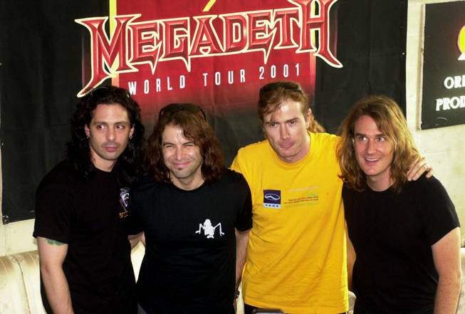 Members of rock band Megadeth, from left to right: Al Pitrelli, Jimmy De Grasso, Dave Mustaine, and David Ellefson, all from San Francisco, California, pose for photographers during a news conference for their concert in Jakarta, Indonesia, Monday, July 30, 2001. Megadeth, currently on a world tour, will perform in Medan, Sumatra island, on Tuesday, July 31, 2001.