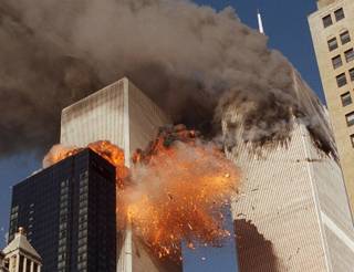 Smoke billows from one of the towers of the World Trade Center and flames and debris explode from the second tower, Tuesday, Sept. 11, 2001. In one of the most horrifying attacks ever against the United States, terrorists crashed two airliners into the World Trade Center in a deadly series of blows that brought down the twin 110-story towers.