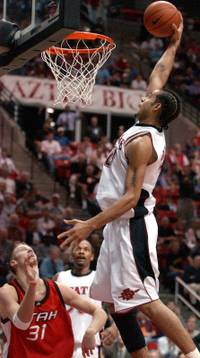 San Diego State's Evan Burns (21) goes up for a dunk over Utah's Britton Johnsen (31) during the second half Saturday, Jan. 18, 2003, in San Diego. San Diego State won 58-56. 