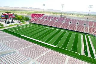 Employees with Sun State Landscaping of Las Vegas continue to install a Turf Technologies Sports Turf at Sam Boyd Stadium Thursday, Aug. 14, 2003. Installation of the turf is nearly 90-percent complete.
