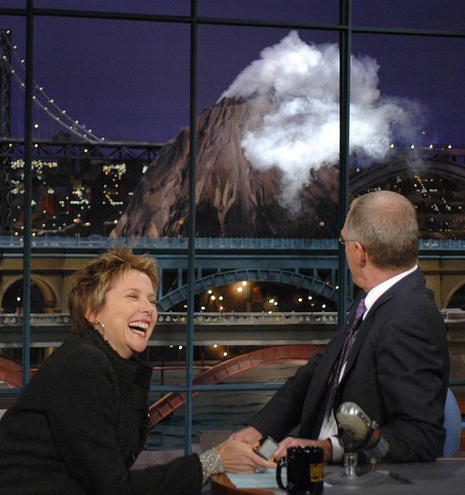 Actress Annette Benning, left, fires up the "Hudson River Volcano" as host David Letterman watches during a taping of "Late Show with David Letterman"  Tuesday, Oct. 5, 2004, in New York.