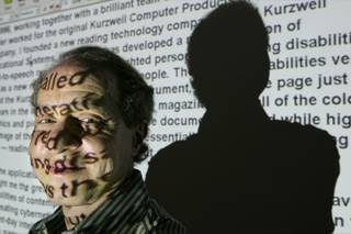 Author and inventor Ray Kurzweil, 56, appears in front of words projected on a screen from his Internet site in his office, in Wellesley, Mass., Jan. 12, 2005. 