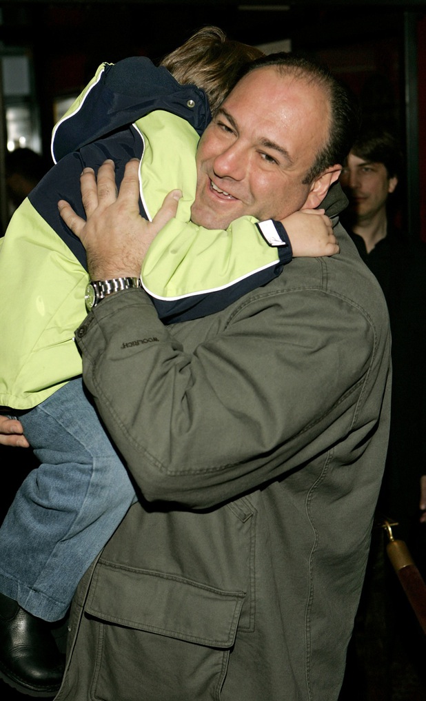Sopranos star James Gandolfini carries his son past photographers at the United States premiere of the film Harry Potter and the Goblet of Fire, in New York, Saturday, Nov 12, 2005.
