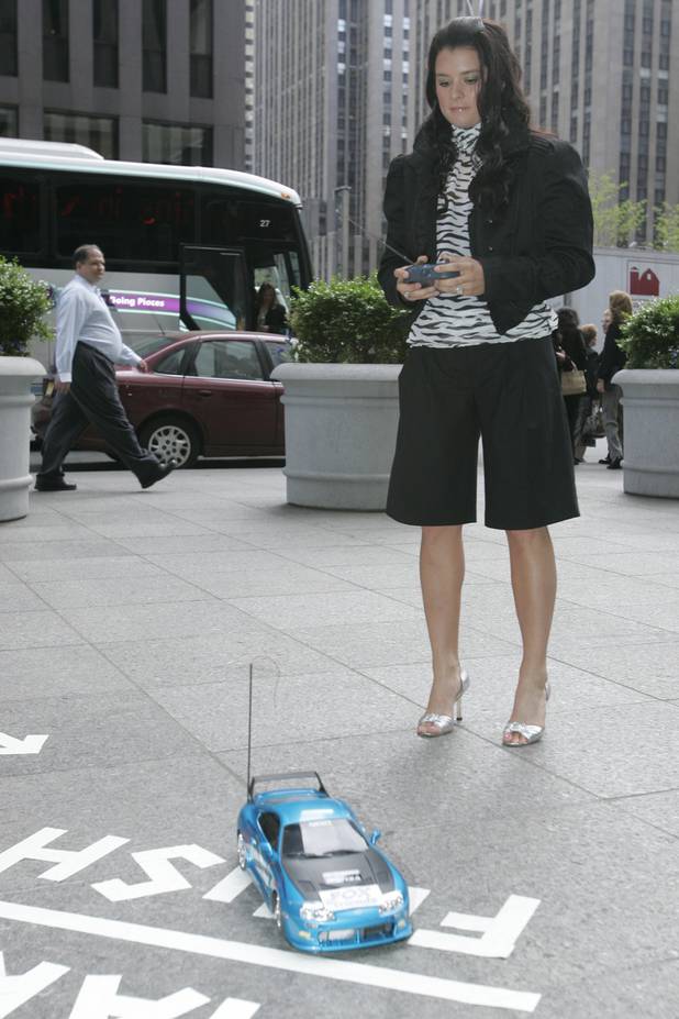 Danica Patrick plays with a remote control toy car before ...
