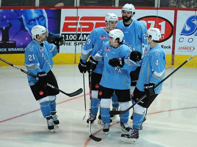 Alaska Aces players come together to congratulate forward Evan Trupp (center) after he scored a second period goal against the Las Vegas Wranglers on Saturday night.