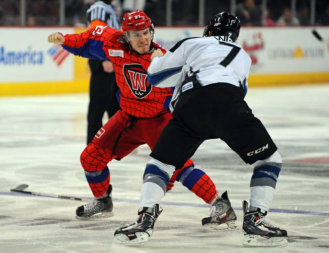 Chad Nehring (23) fights Mitch Wahl near the start of the third period of play between the Las Vegas Wranglers and the Idaho Steelheads on Saturday night.
