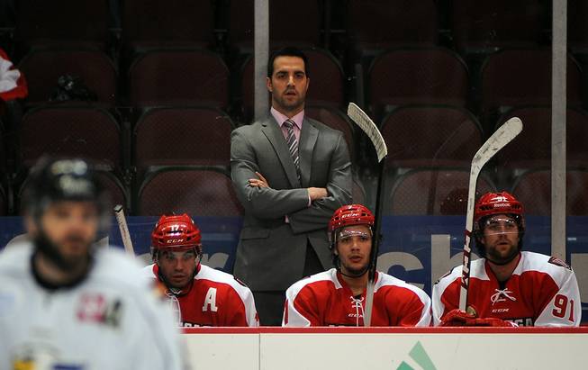 Las Vegas Wranglers head coach Mike Madill watches from behind the bench during a game against the Colorado Eagles on Tuesday night.