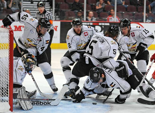 Colorado Eagles players swarm around the puck to help protect their net during the third period of a game at the Orleans Arena on Wednesday night.