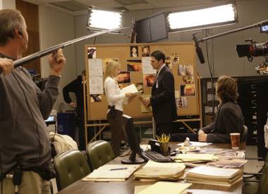 Cast members of the “Criminal Minds” television series, A.J.Cook, center left, and Thomas Gibson, tape a scene Wednesday, Jan. 9, 2007, while on location in Long Beach, Calif. (AP Photo/Nick Ut)