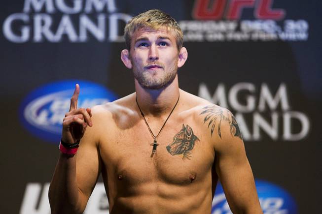 Light heavyweight Alexander Gustafsson poses on the scale during the UFC 141 weigh-in at the MGM Grand Garden Arena Thursday, Dec. 29, 2011.
