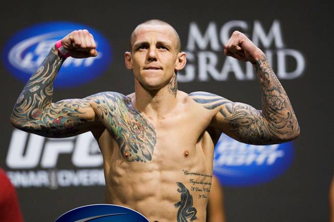 Featherweights Ross Pearson poses on the scale during the UFC 141 weigh-in at the MGM Grand Garden Arena Thursday, Dec. 29, 2011.