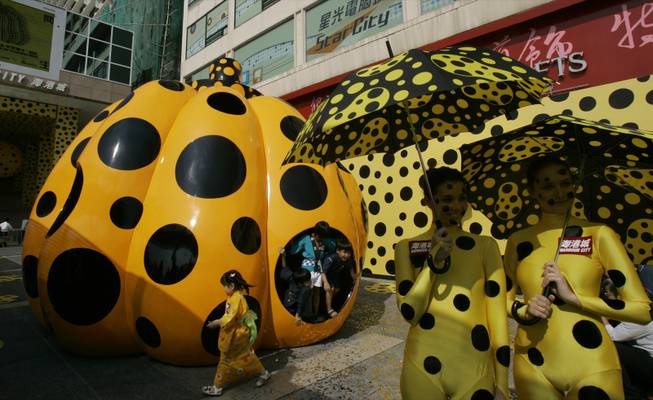 Yayoi Kusama - Models pose in front of the giant pumpkin which is ... -