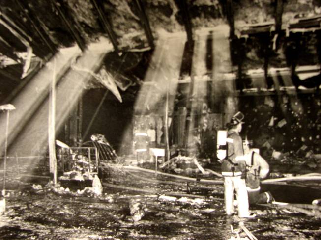 Light cascades down on Firefighters as they sift through the rubble of the MGM Grand Hotel's lobby. The fire began Nov. 21, 1980 on the Casino floor, but quickly spread to the lobby and main entrance of the hotel. 