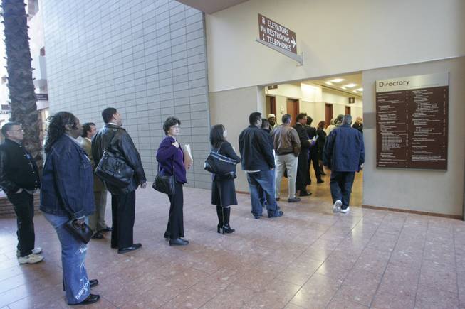 People queue up for the elevators at the Regional Justice Center on Tuesday. The elevators for the public are known to break down or make unplanned stops. 